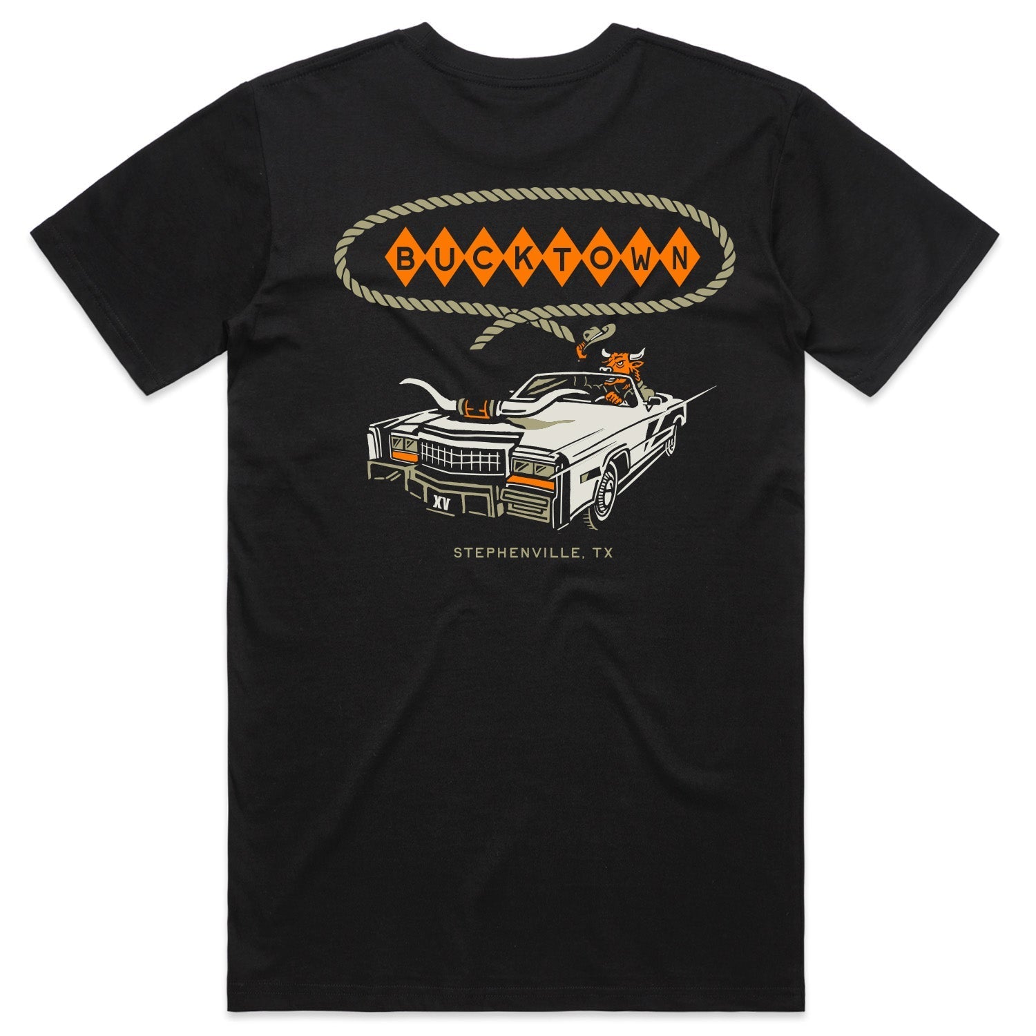 The Bucktown Caddie Tee by Rural Cloth features a rodeo-inspired graphic of a white Cadillac with a cowboy and steer, "BUCKTOWN" in a rope-design speech bubble, and "STEPHENVILLE, TX" printed below. Available in black.